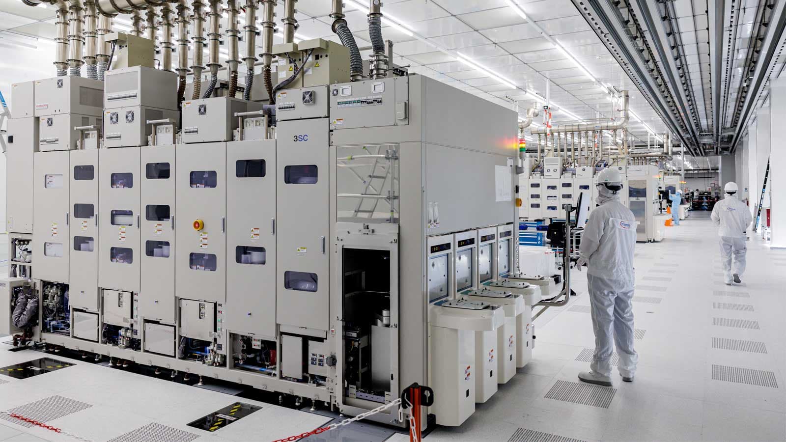 A worker with a wafer polishing machine.