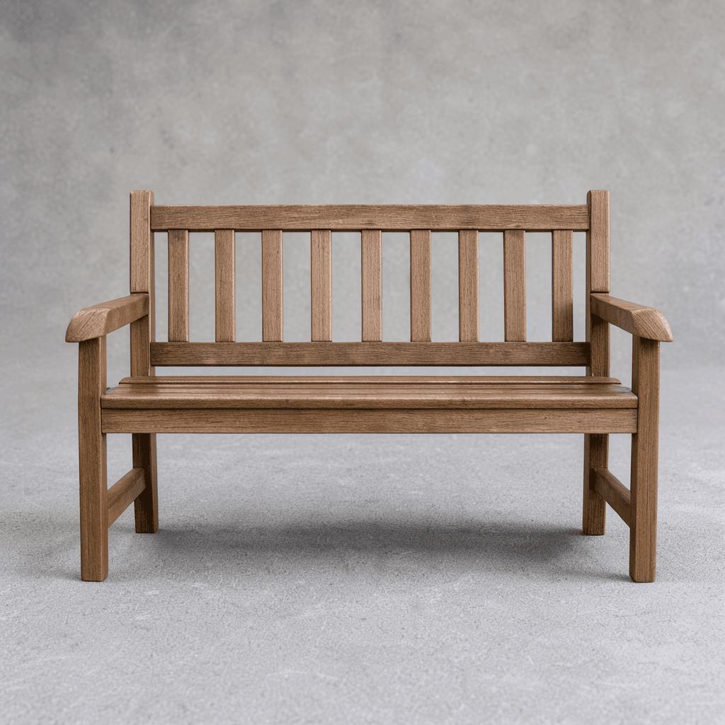 A slatted wooden bench against a plain grey wall
