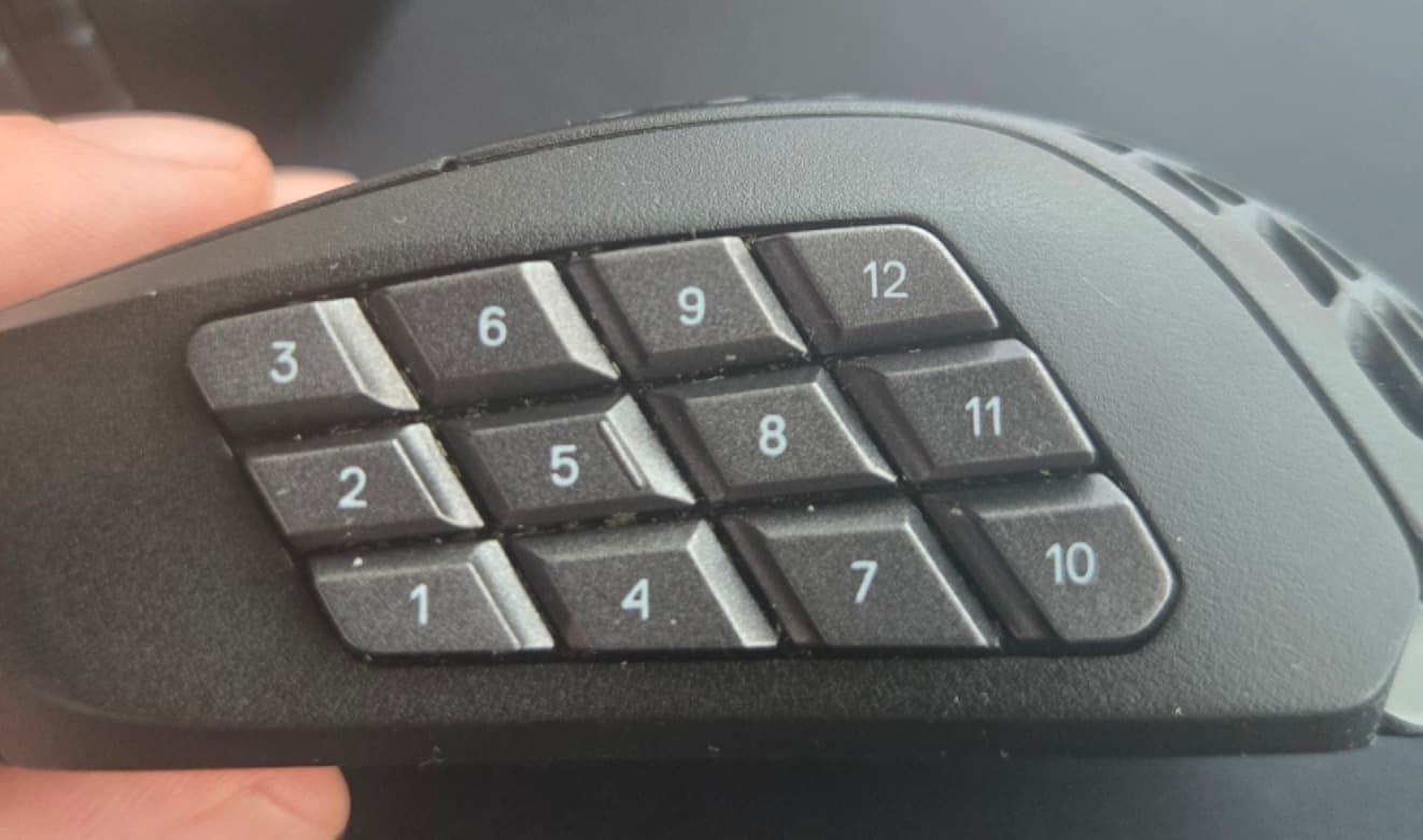 A close up image of the 12-button grid on a SteelSeries Aerox 9 MMO mouse.