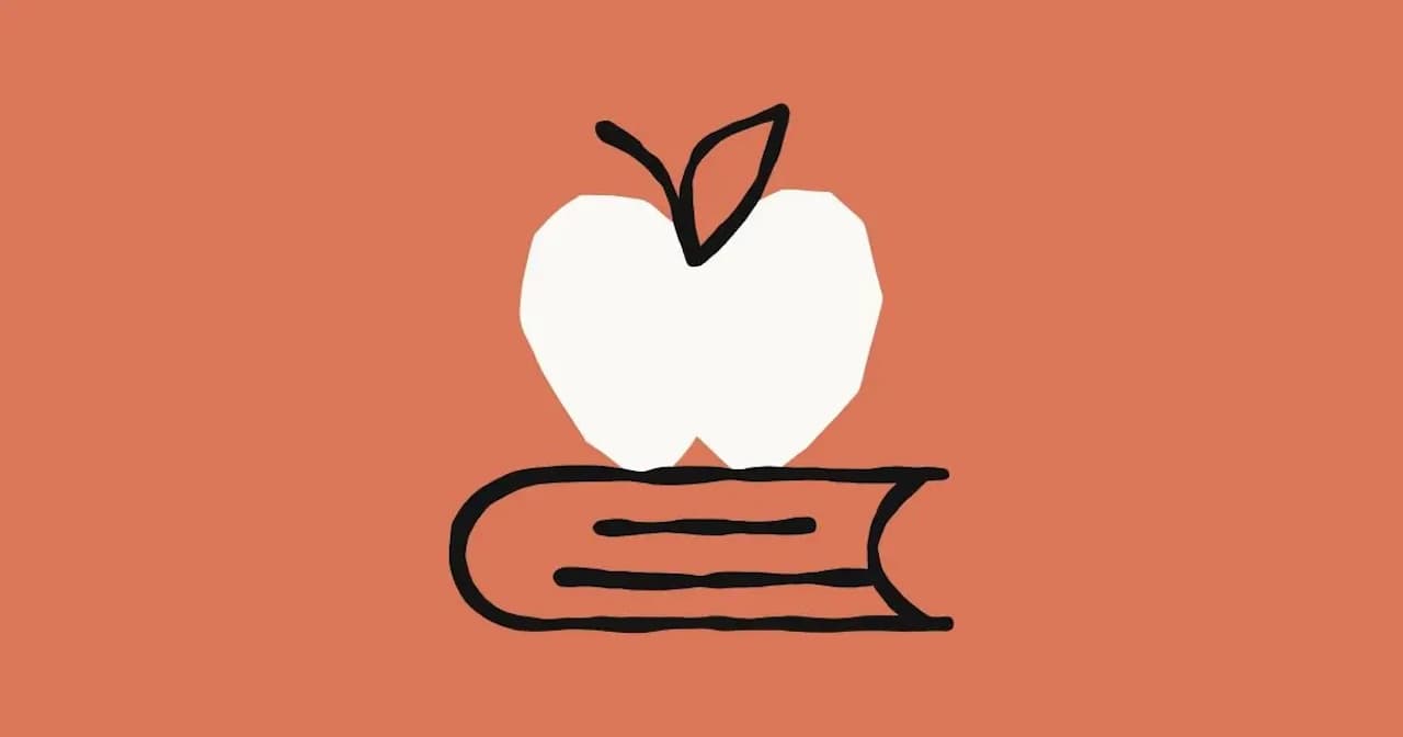 A white apple on a black book against an orange background symbolizes teaching and learning materials.